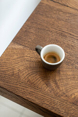 espresso in a gray ceramic cup on a wooden table. espresso. coffee. black coffee. coffee espresso