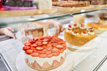fresh pastries with berries. A variety of fresh pastries in the bakery window. Strawberry cake. The interior of an Italian restaurant.
