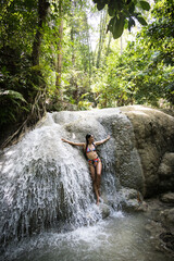 girl posing in a waterfall
