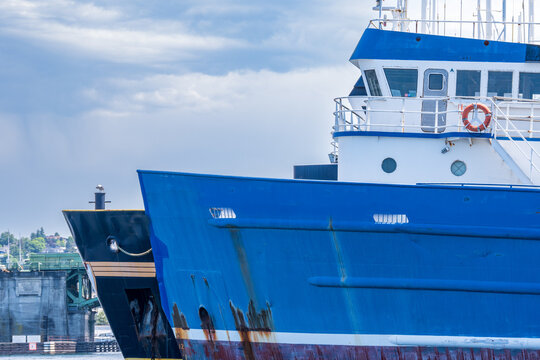 Industrial fishing ships idle in  harbor: two bows shot in ballard seatle washington