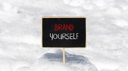 Brand yourself symbol. Concept words Brand yourself on beautiful black blackboard. Beautiful snow background. Business brand yourself concept. Copy space.
