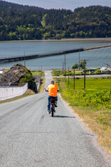 Bicyclist Rides down hill towards Tommy Thompson trail