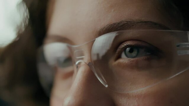 Innovation, Scientific researcher of a white girl's eye in protective glasses in a medical facility. In slow motion Microbiology specialist Works in the workroom Creating a study strategy, experiments