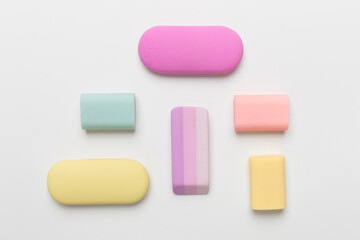 Colorful erasers on color backgroung, top view