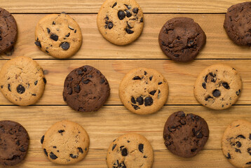 Flat lay with chocolate chip cookies on wooden background