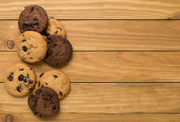 Flat lay with chocolate chip cookies on wooden background