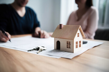 Happy Married Couple  Signing Mortgage Agreement: Home Loan and Property Buying Concept