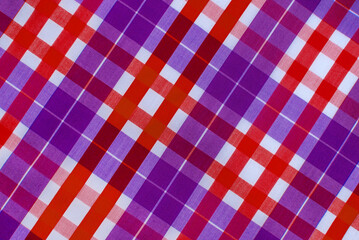 The texture of linen fabric in a large cell of red and blue. Scottish tailoring material