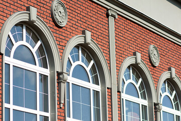 Beautiful panoramic windows in a building with red brick walls.  Architecture
