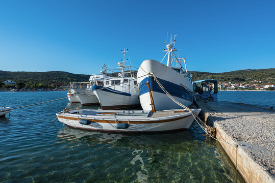 Fisherman boats in the harbour of small Marina town in Croatia.