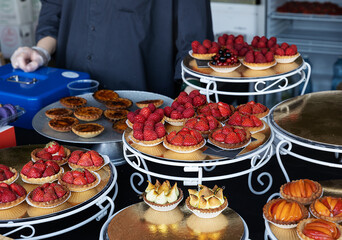 counter with berry tarts at a street food market

