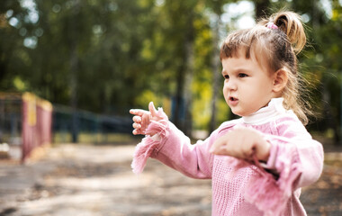 Angry displeased and distressed little girl, the child looks furious and upset. active holidays in...