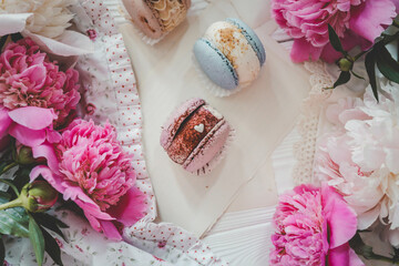 Macaroons and peonies, flat lay top view