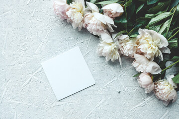 Greeting card with place for your text and white peonies top view