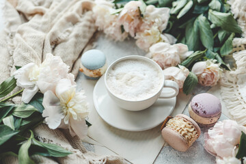 Cup of coffee, sweet macaroons and white peonies, beautiful aesthetic photo