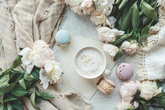 Cup of coffee, sweet macaroons and white peonies, beautiful aesthetic photo