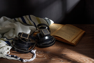 A photograph of ritual Jewish objects Tefillin, Tallit, Tora.