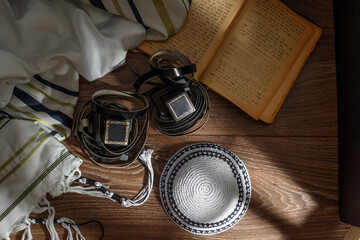 A photograph of ritual Jewish objects Tefillin, Tallit, Tora.