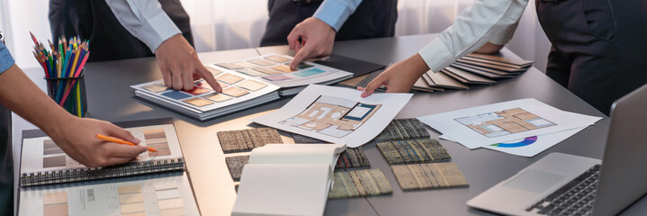 Group of interior designer team in meeting, discussing with engineer on interior design and planning for house project blueprint and model, choosing various mood board materials. Insight