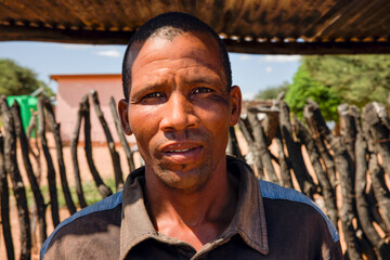 village african man standing under the metal shed