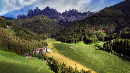 Poster Stunning Alpine scenery of breathtaking Dolomites rocks mountains in Italian Alps, South Tyrol, Italy. Aerial view of Val di Funes and village Maddalena, Valley Isarco © Freesurf