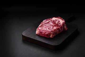 Fresh, raw beef steak with salt, spices and herbs