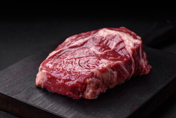 Fresh, raw beef steak with salt, spices and herbs