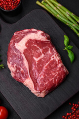 Fresh, raw beef steak with salt, spices and herbs