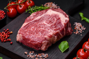 Fresh, raw beef steak with salt, spices and herbs