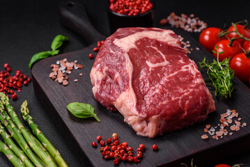 Fresh, raw beef steak with salt, spices and herbs