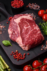 Fresh, raw beef steak with salt, spices and herbs