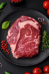 Fresh, raw beef steak with salt, spices and herbs