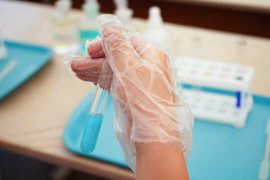 kids in science lab study using pipette dropping liquid to test tube , caucasian , biochemistry . chemistry class