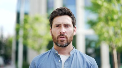 Headshot portrait confident mature handsome businessman man in casual serious look at camera. Business male entrepreneur or university college teacher near office building city street outside Closeup