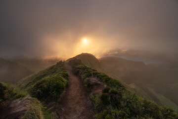 Naklejka premium Foggy sunset on the top of a panoramic view