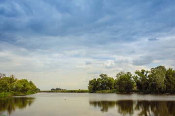 beautiful lake at the evening. Landscape - meadow, the blue sky and river