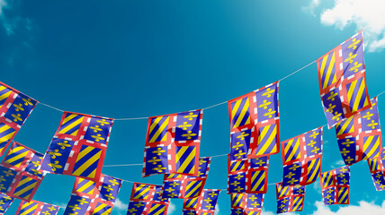 Flag of Borgona - France against the sky, flags hanging vertically