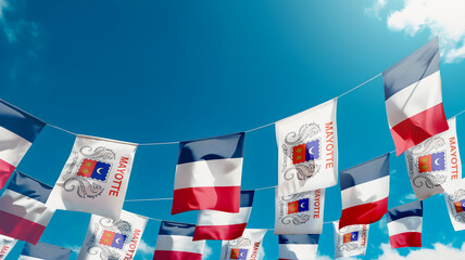 Flag of Mayotte - France against the sky, flags hanging vertically