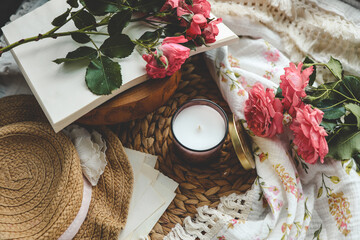 Candle in an aesthetic spring interior with roses