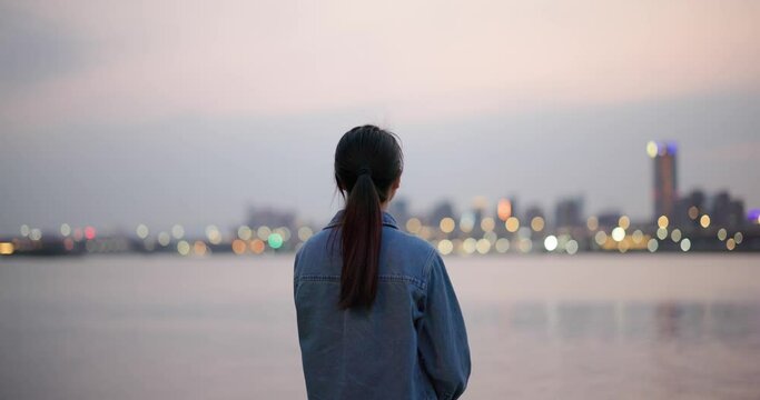 Asian woman look at the view with river
