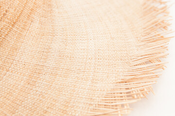 Light straw wicker hat as abstract summer fashion accessory background on white color