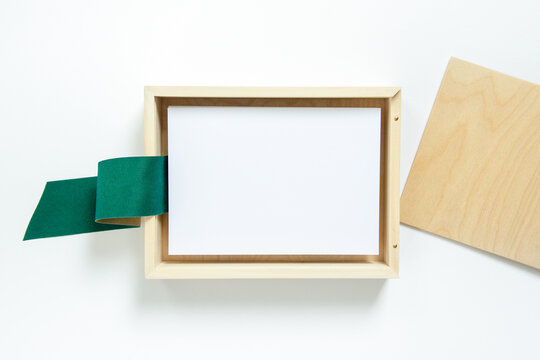 Blank cards in a wooden box with a green ribbon