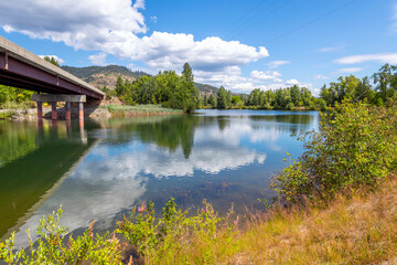 Obraz premium The Coeur d'Alene River as it runs through the Cataldo area along the White Pine Scenic Byway near Rose Lake, Idaho USA.