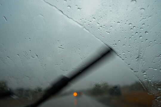 car windshield wipers clean glass from rain close up