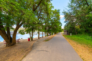 The Trail of the Coeur d'Alenes as it runs past a small sandy beach at the small lakeside town of Harrison, Idaho, USA, in the general Coeur d'Alene area of North Idaho.