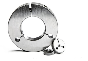 Three metal gauges of different sizes on a white background