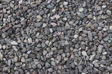 Gravel texture background. Pebble sea beach close-up, dark wet pebble and gray dry pebble.