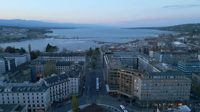 Flight over the city of Geneva by night - aerial view by drone