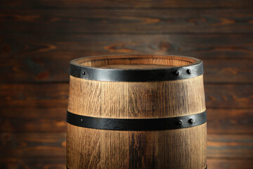 Fototapeta premium One wooden barrel near wall, closeup view