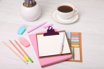 To do notes, planner, stationery and coffee on white wooden table